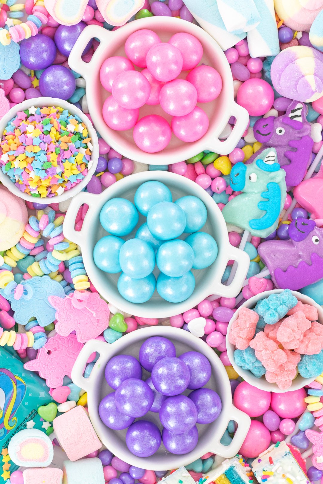 pretty tray of unicorn candy and gum. pink, blue, purple. unicorn candy bracelets