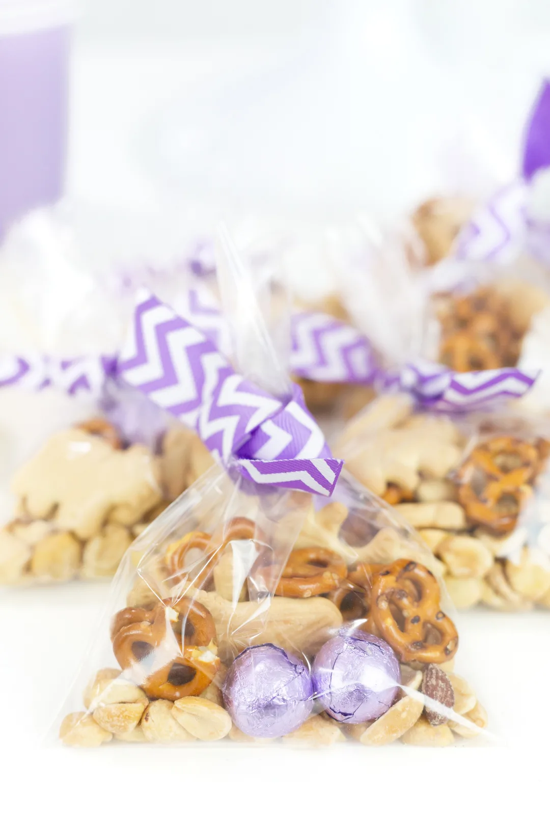 individual snack baggies with purple striped ribbon tied around