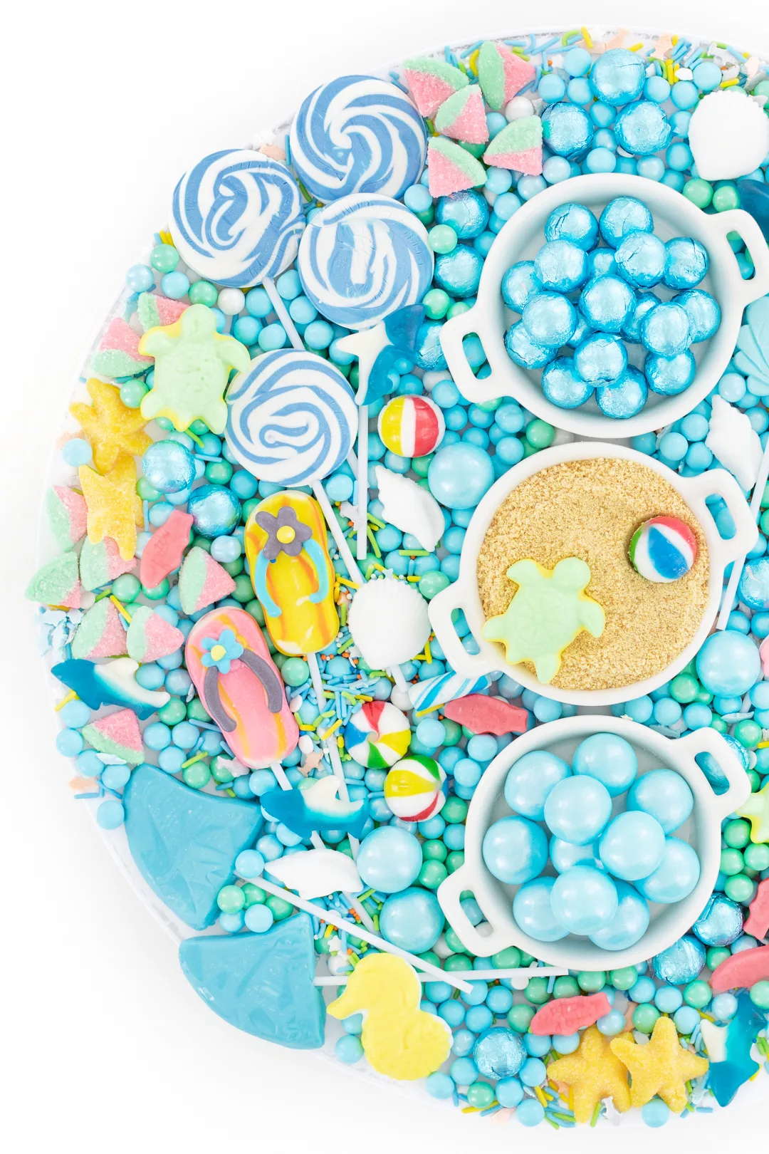 candy platter with a beach theme. flip flop lollipops, sea creature gummy candies