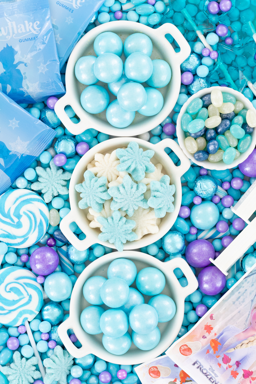 close up of candy tray. shimmery blue gumballs, snowflake shaped candy, shimmery jelly beans.