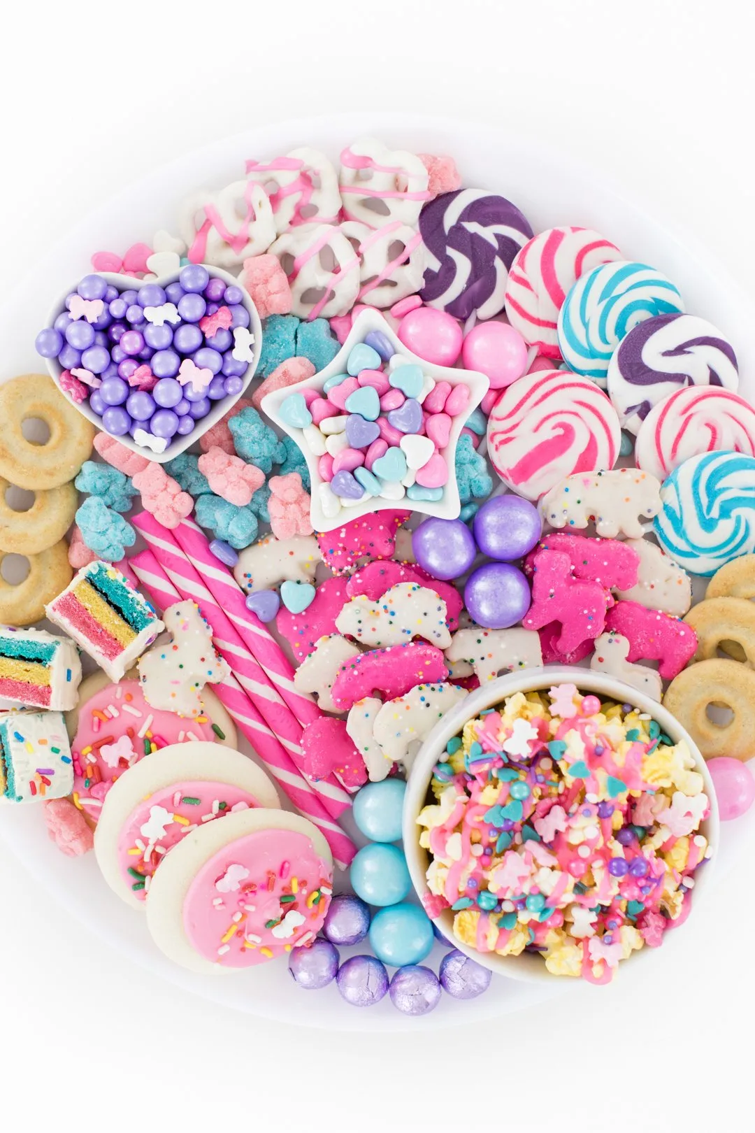 pretty pastel snack tray with popcorn, candy sticks, gumballs, pastel covered pretzels