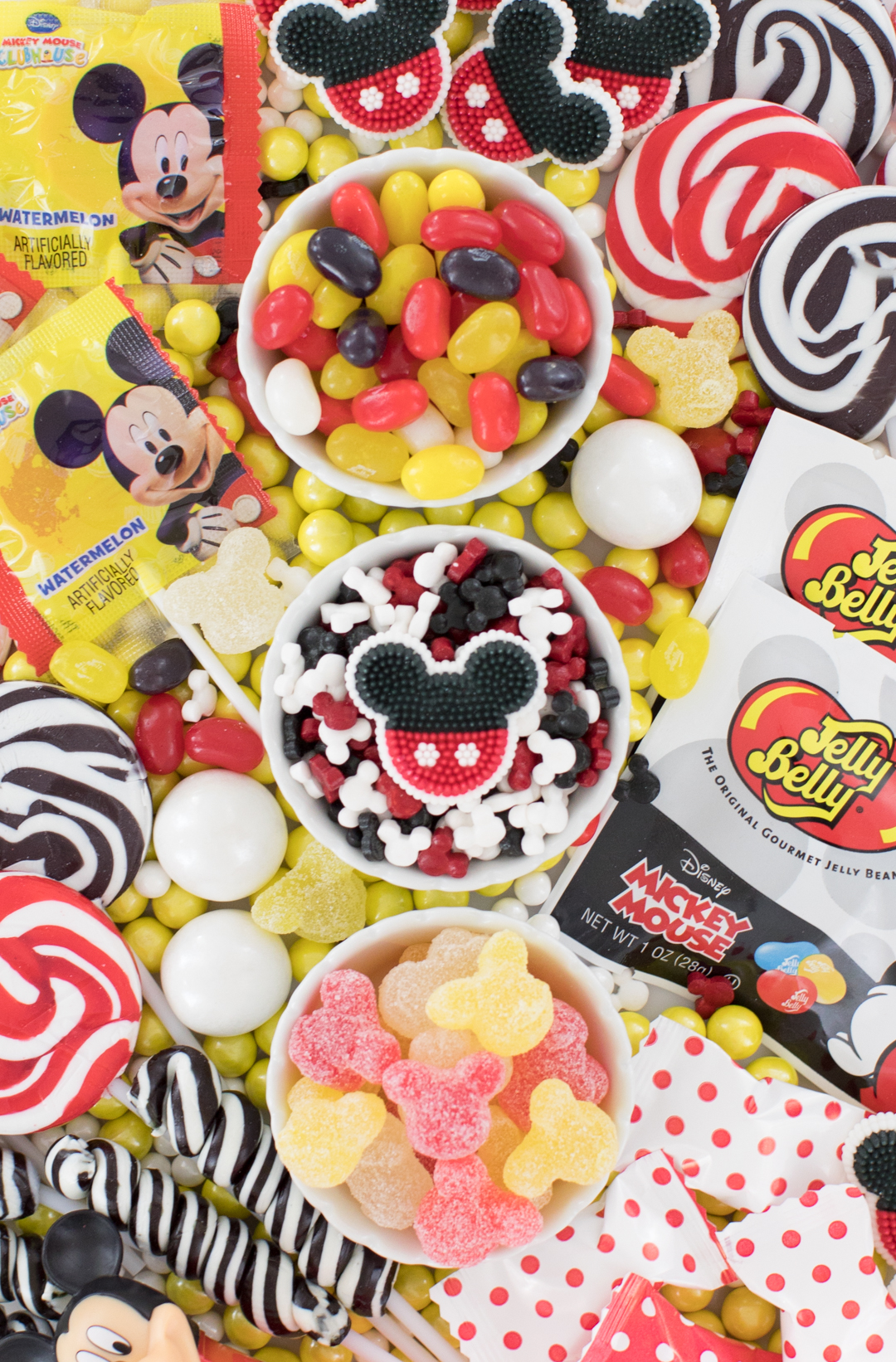 tray of mickey mouse inspired candies that are black, white, yellow and red