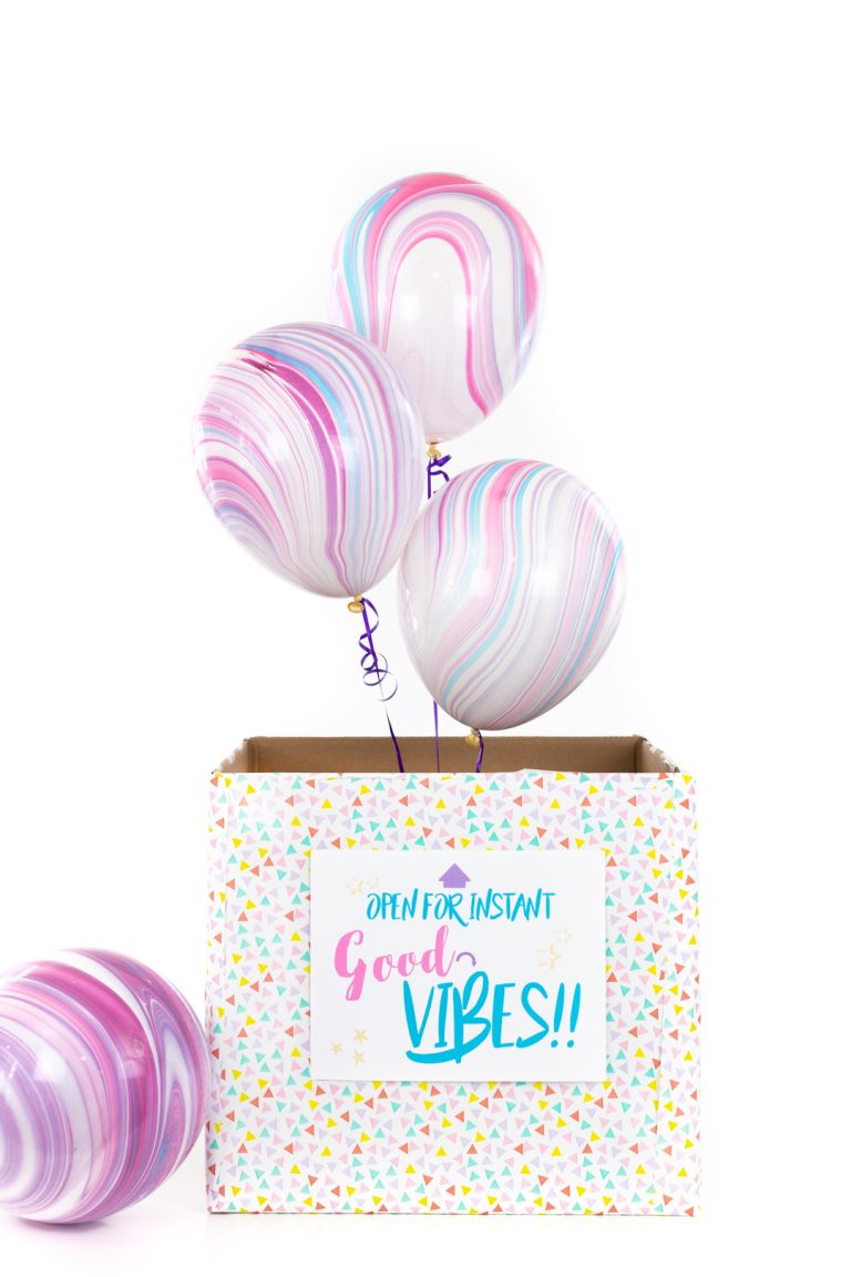 balloons popping out of a box surprise