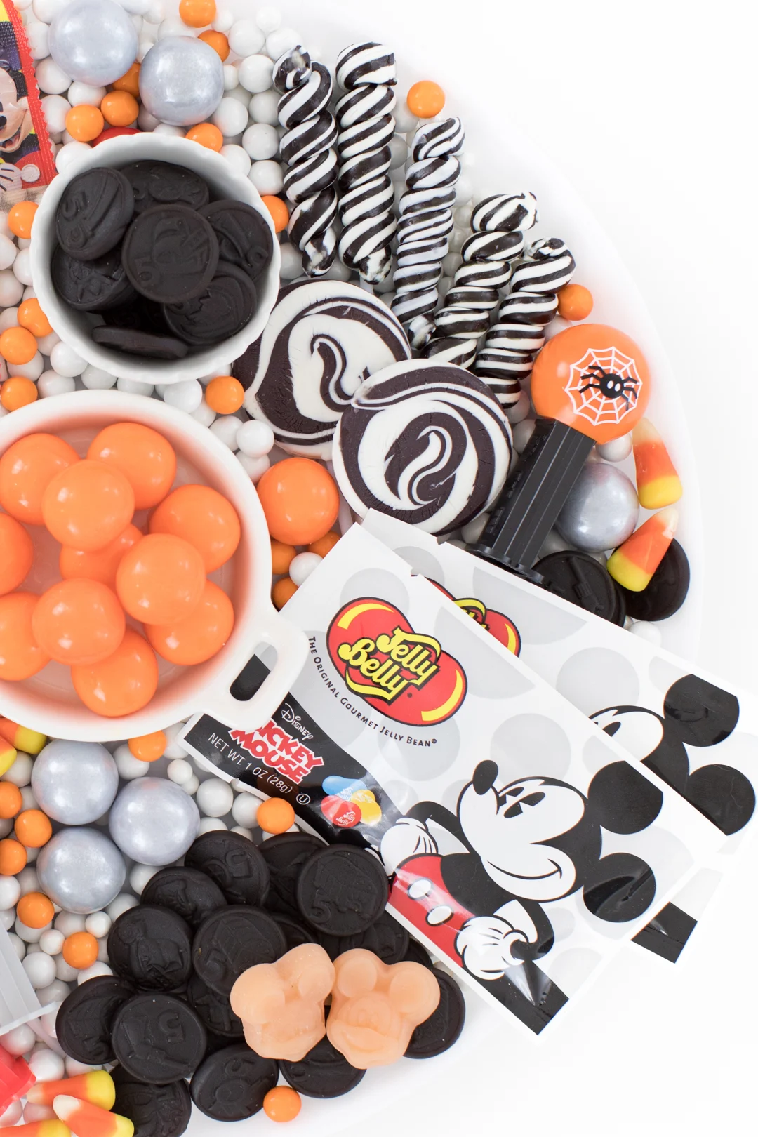 Mickey Mouse Halloween Candy Charcuterie Board with Jelly Belly and Swirl Lollipops.