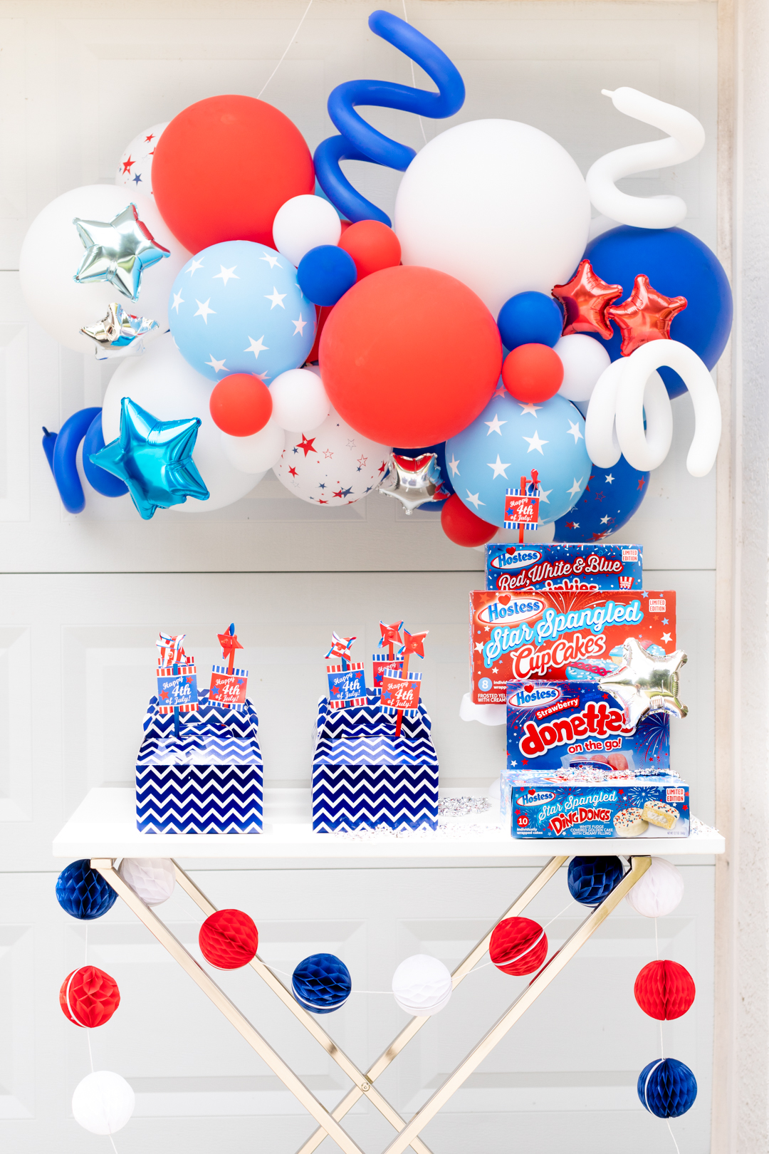 outdoor party table decorated with patriotic balloons