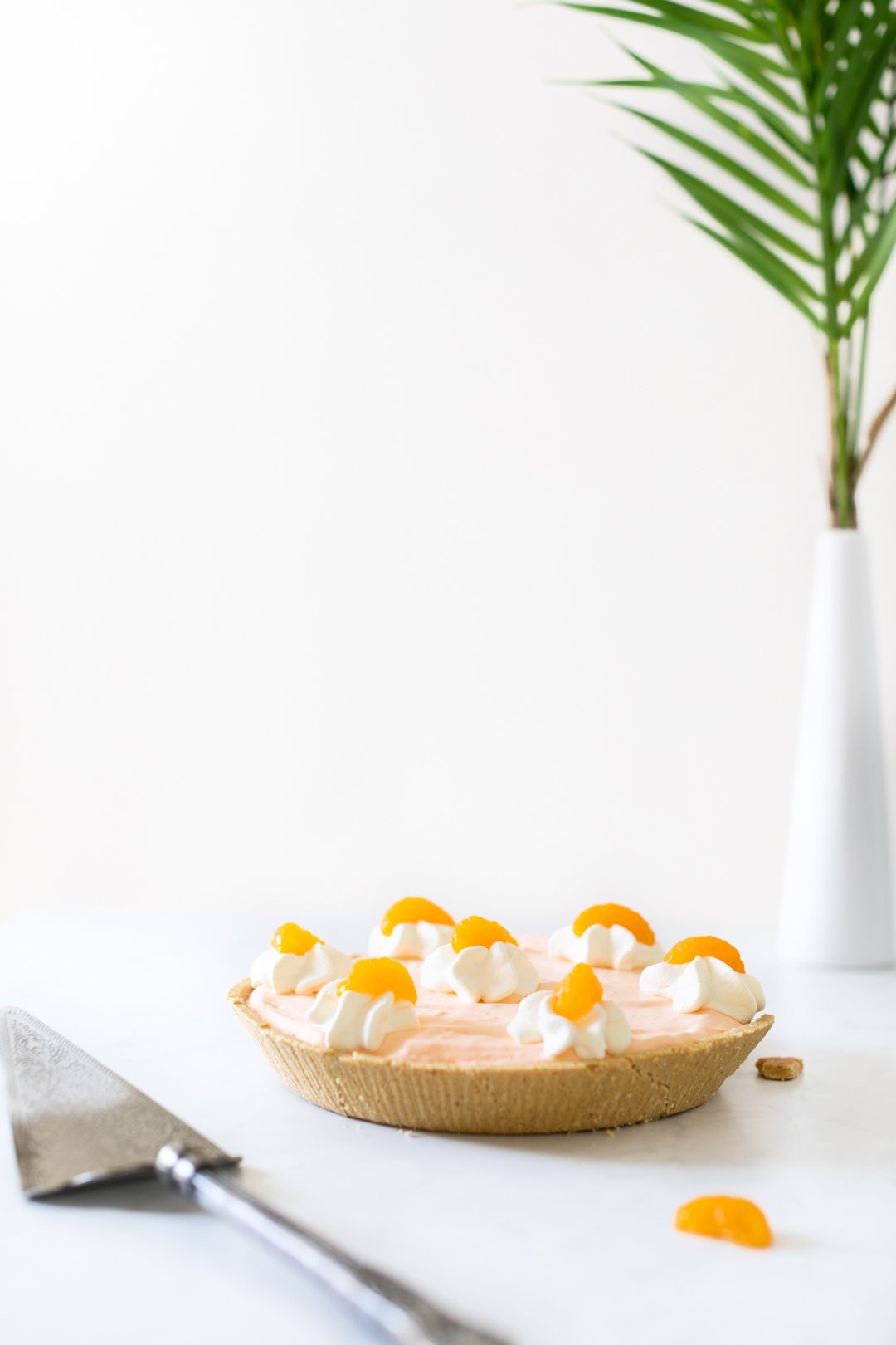 perfect summer pie topped with fruit setting on table with light shining in