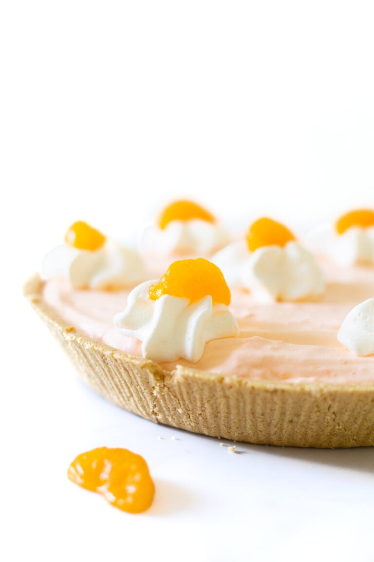 mandarin orange pie close up with whipped cream and mandarin orange garnish