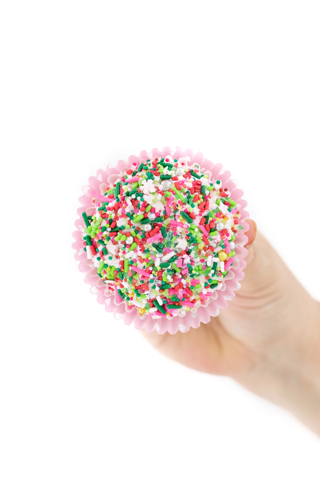 dipping frosted cupcakes into sprinkles to get them to stick