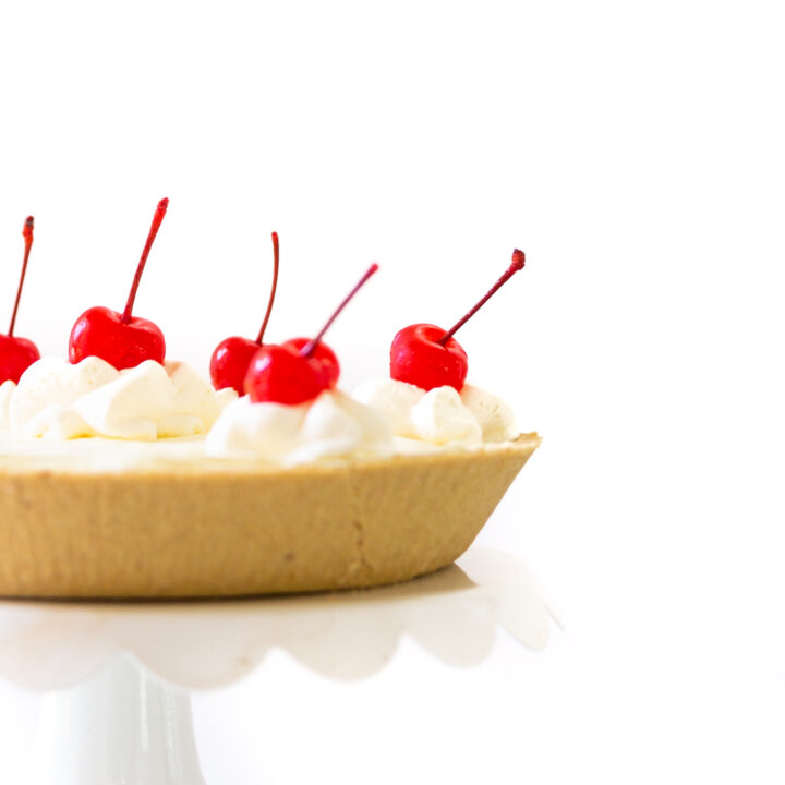 Pretty summer pie on a white cake stand.