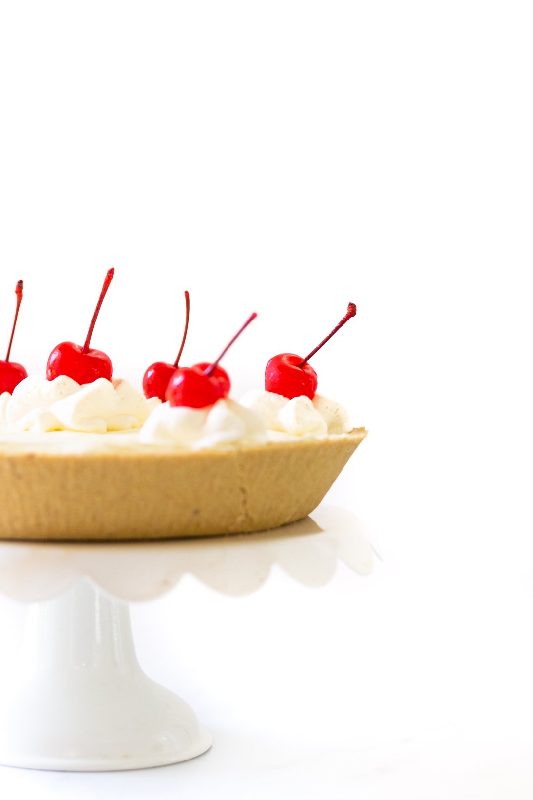 Pretty summer pie on a white cake stand.