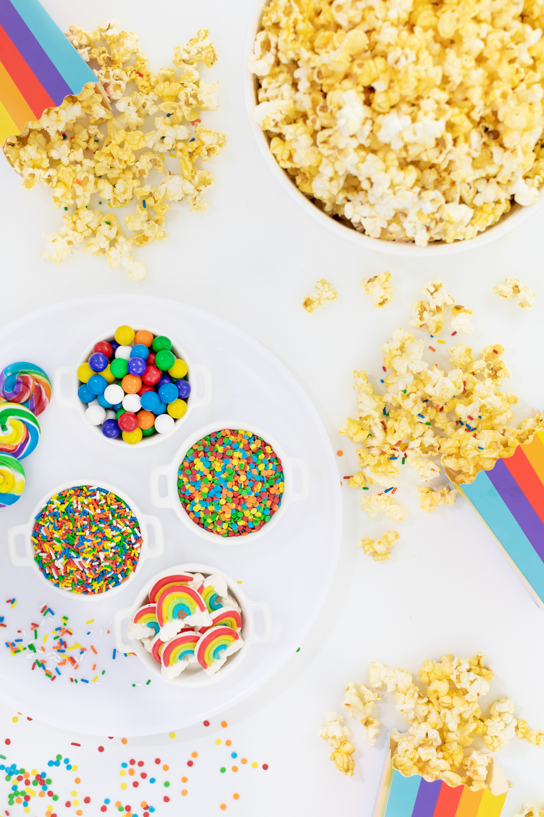 colorful popcorn party table with sprinkles and candies