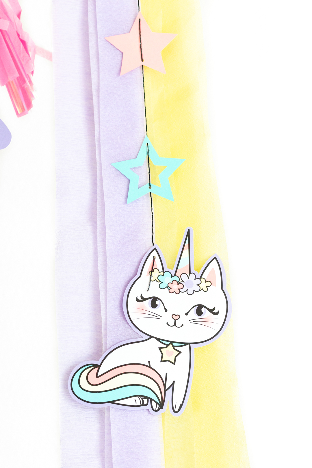 caticorn hanging decoration against yellow and purple streamers