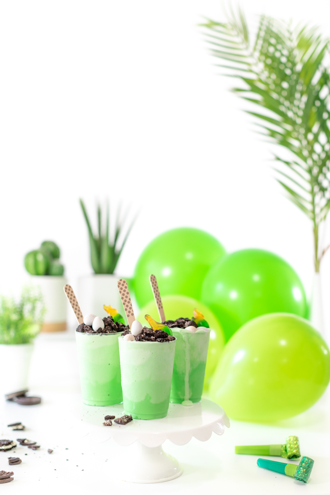fun dino party setting with dino themed desserts