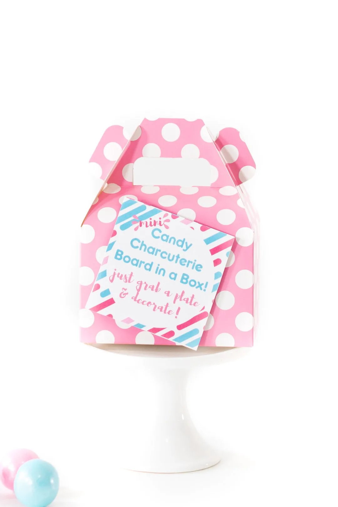 close up of small pink polka dot favor box with gift tag on it