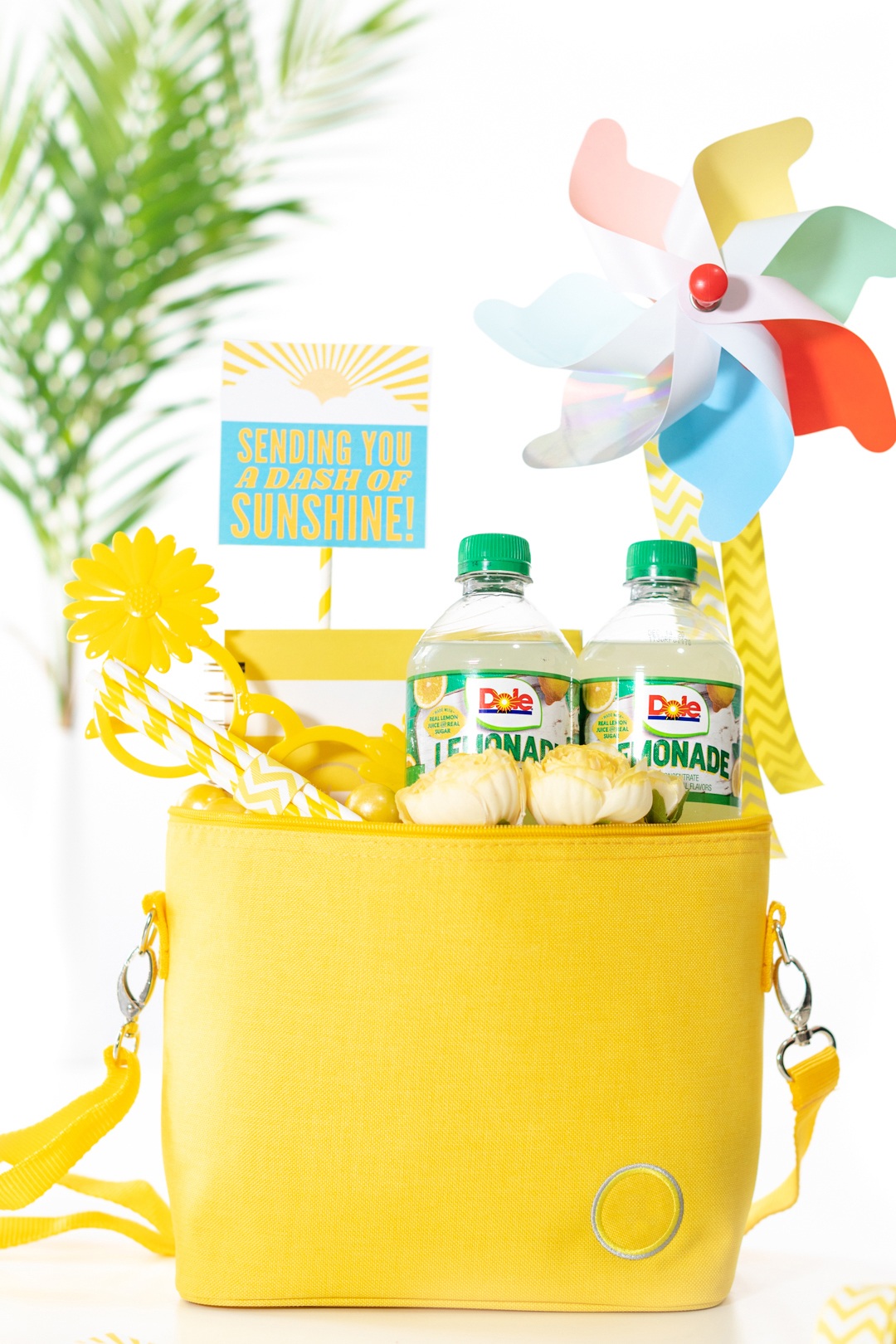diy gift basket that is yellow themed. All gift trinkets are placed into a yellow mini cooler to deliver "sunshine" to a friend