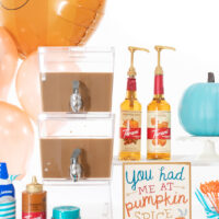 iced coffee bar with double beverage dispenser, pumpkin spice sign, torani fall inspired syrups, sauces and more.