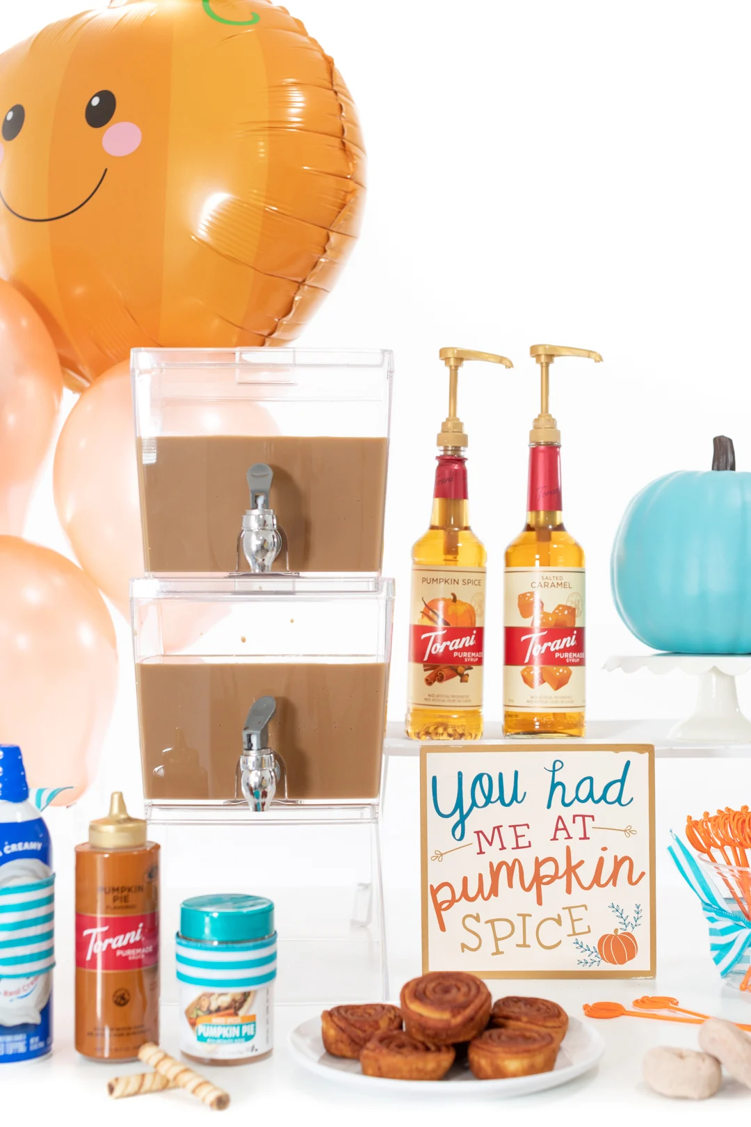 iced coffee bar with double beverage dispenser, pumpkin spice sign, torani fall inspired syrups, sauces and more.