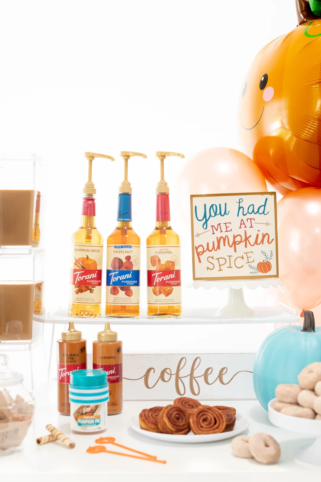 Easy coffee bar for fall featuring iced coffee, mini donuts, pecan swirls and more treats