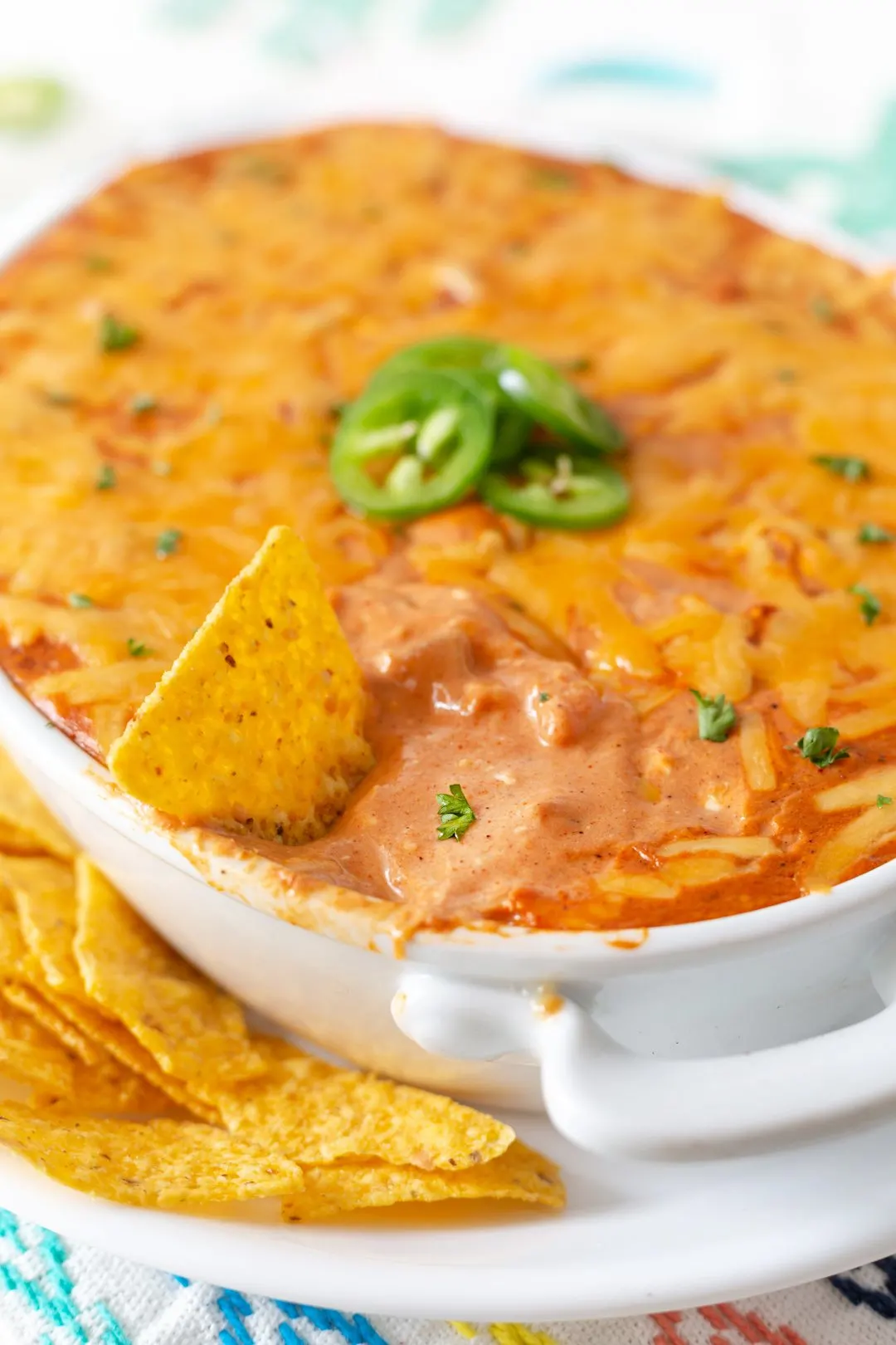 Delicious fiesta dip up close with sliced jalapenos and melty cheese