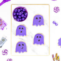 purple ghost cookies on a marble serving tray