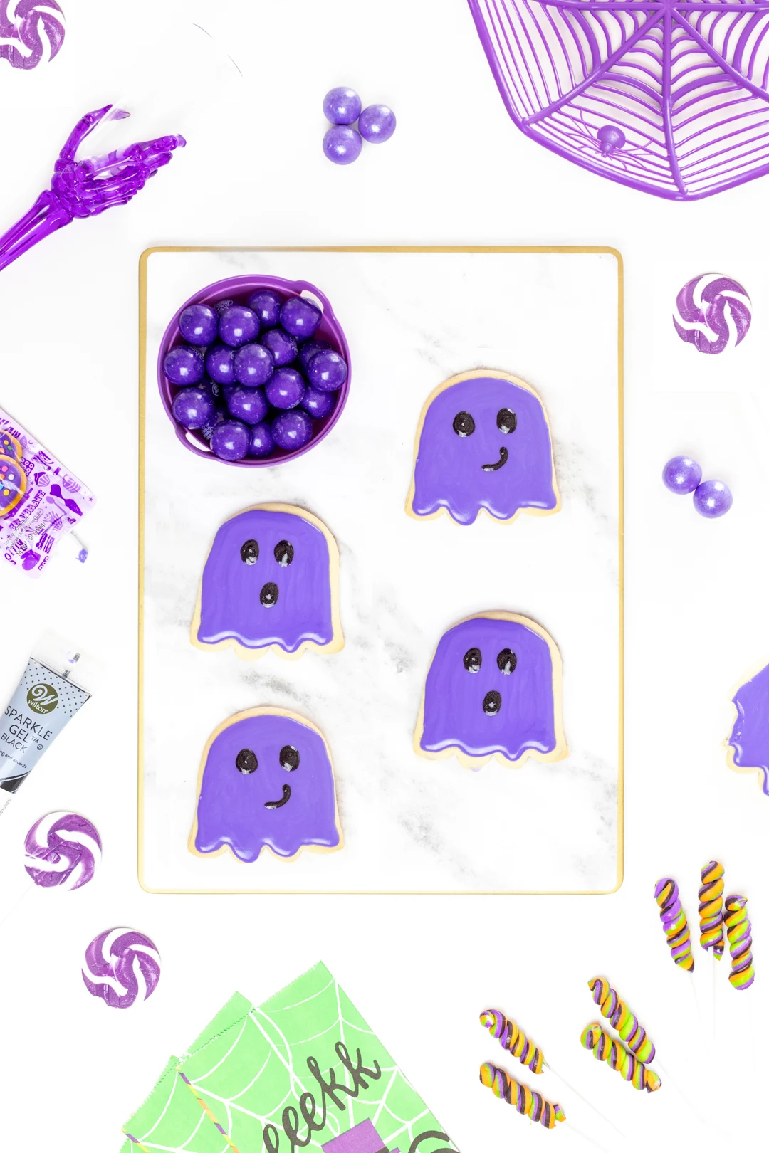 purple ghost cookies on a marble serving tray