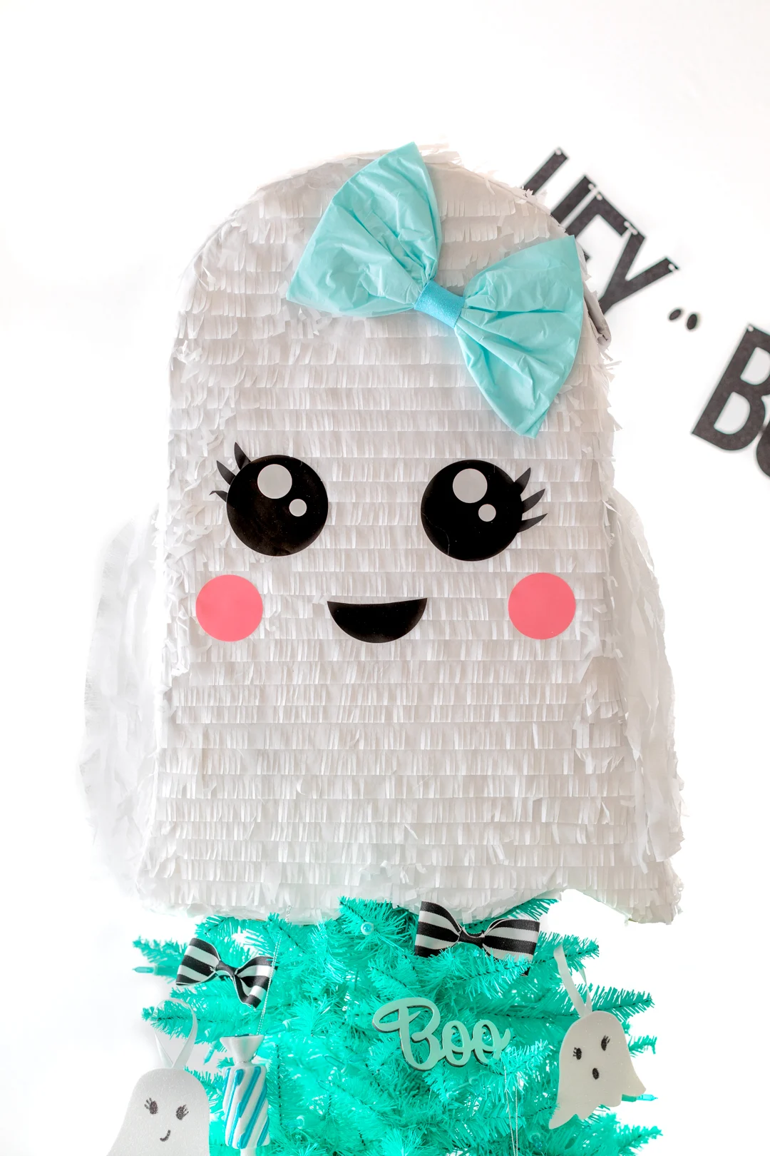 best ghost pinata with a teal bow used as a tree topper for halloween