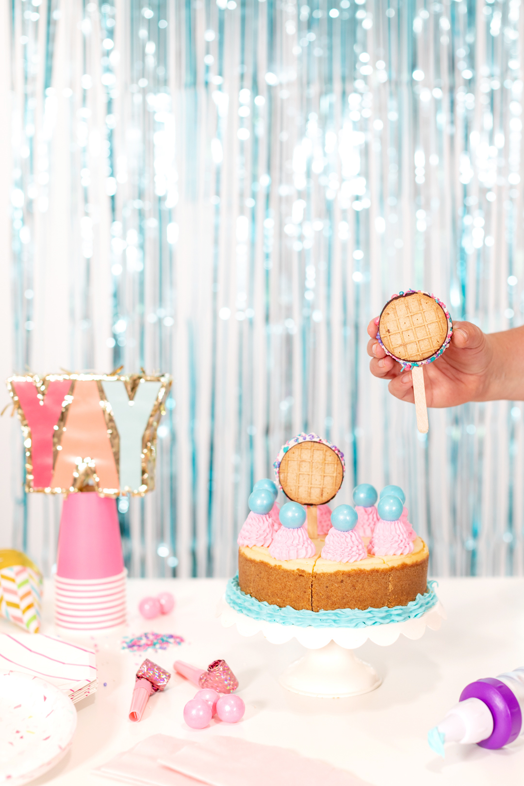 Adding ice cream sandwiches to the top of a birthday cake
