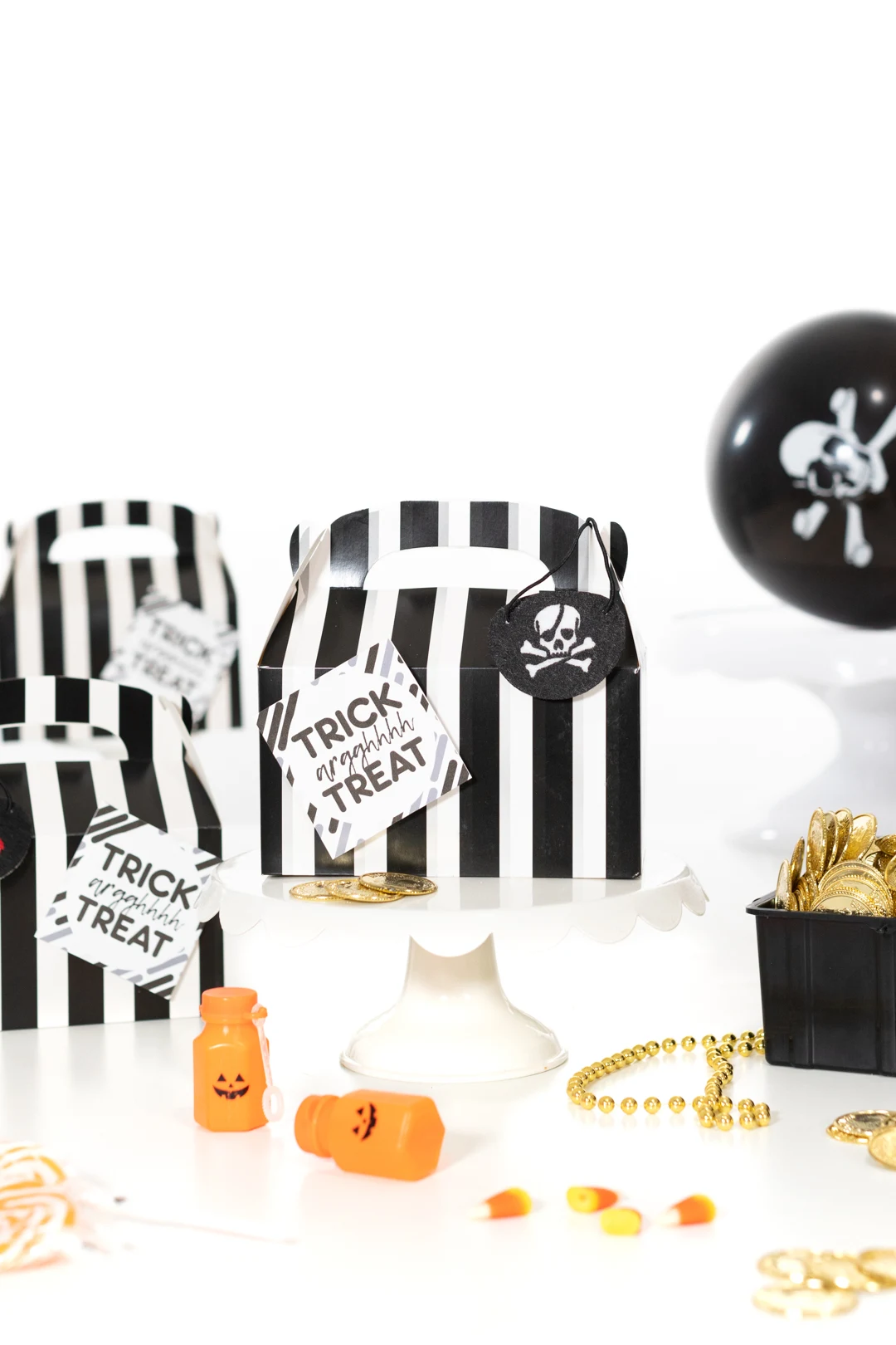 pirate favor boxes, black and white striped with gift tag on them that says trick arrgghh treat on it. Cute for Halloween door drops.