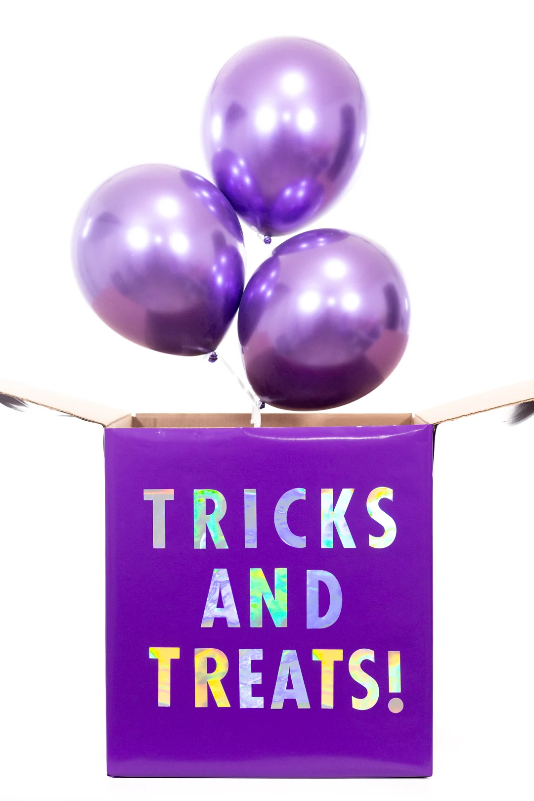 purple halloween diy gift box with metallic purple balloons coming out of it.