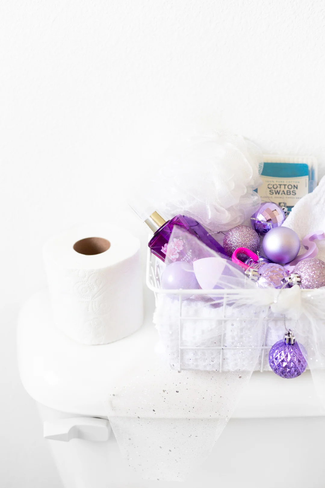 up close of purple christmas themed toiletries basket in a guest bathroom