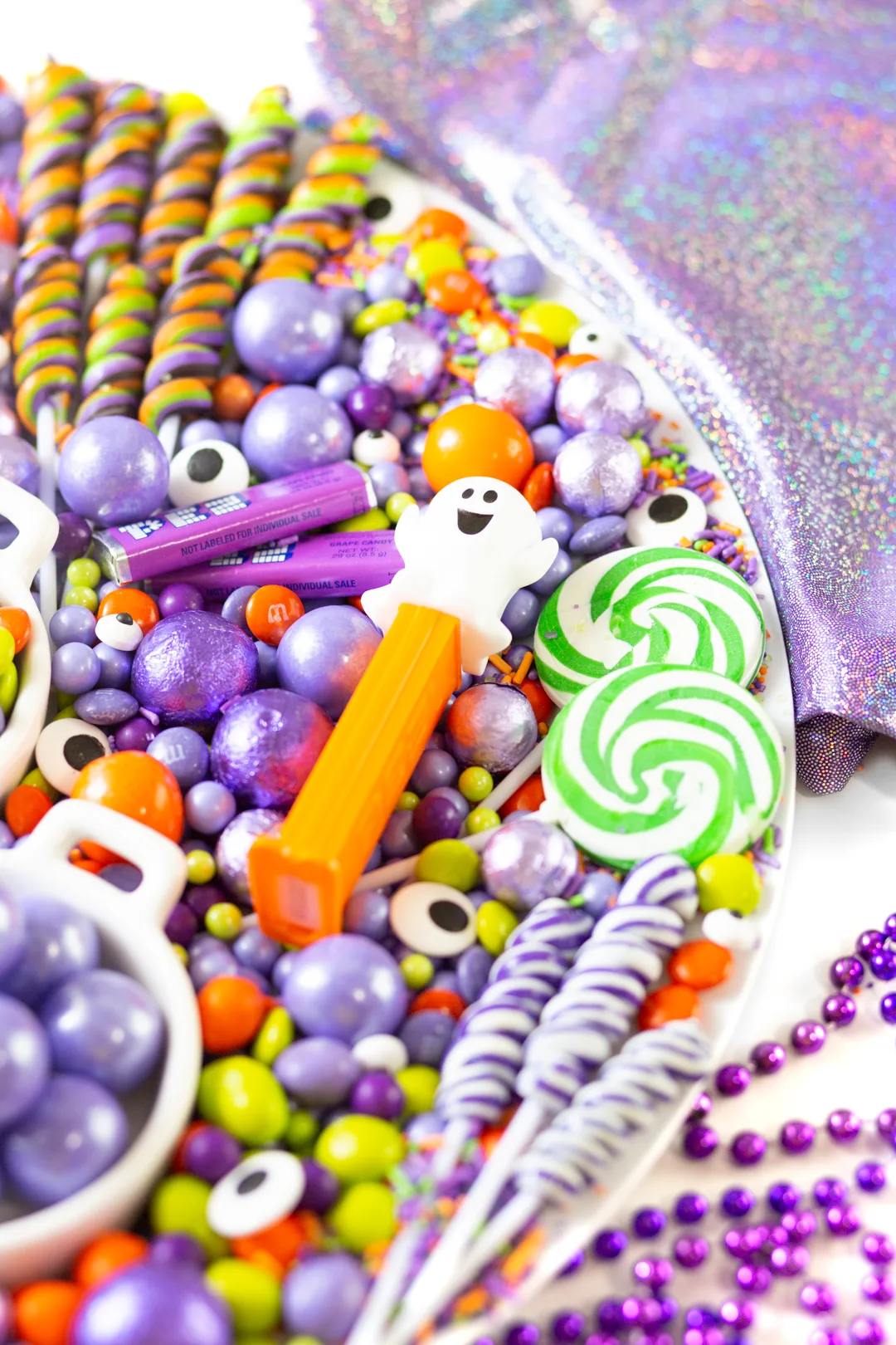 Ghost Pez dispenser, green swirl lollipops, purple swirl lollipops, eye candy