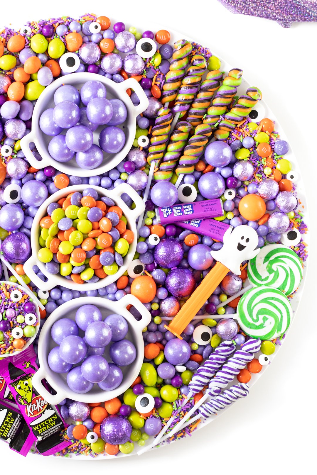 halloween grazing tray filled with candies. halloween m&ms, lollipops, ghost pez and more.