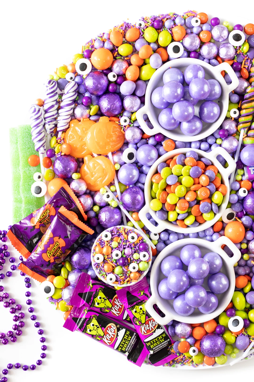 halloween candy selection. green, purple and orange. Halloween M&Ms, Gumballs, Jack o lantern Lollipops, witch chocolates