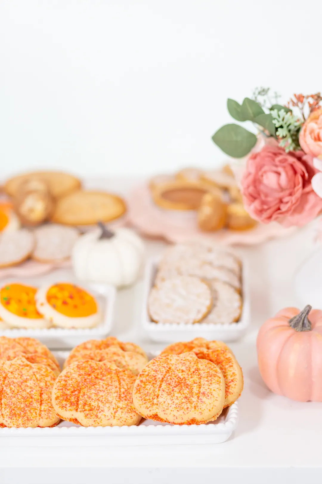pumpkin-shaped cookies with orange sprinkles