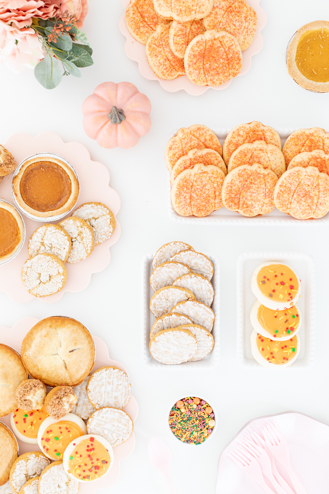 spread of amazing thanksgiving desserts with mini pies, pumpkin cookies, oatmeal cookies and more