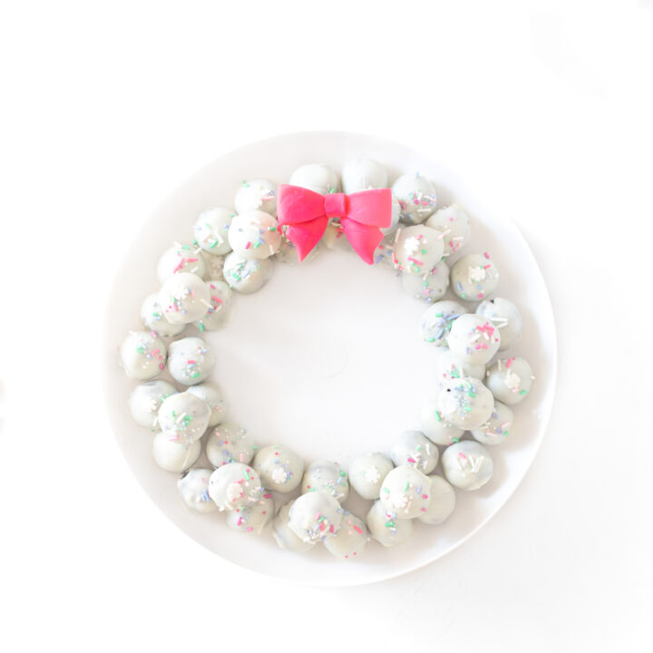 pretty OREO cookie wreath made with white OREO cookie balls and a fondant pink bow.