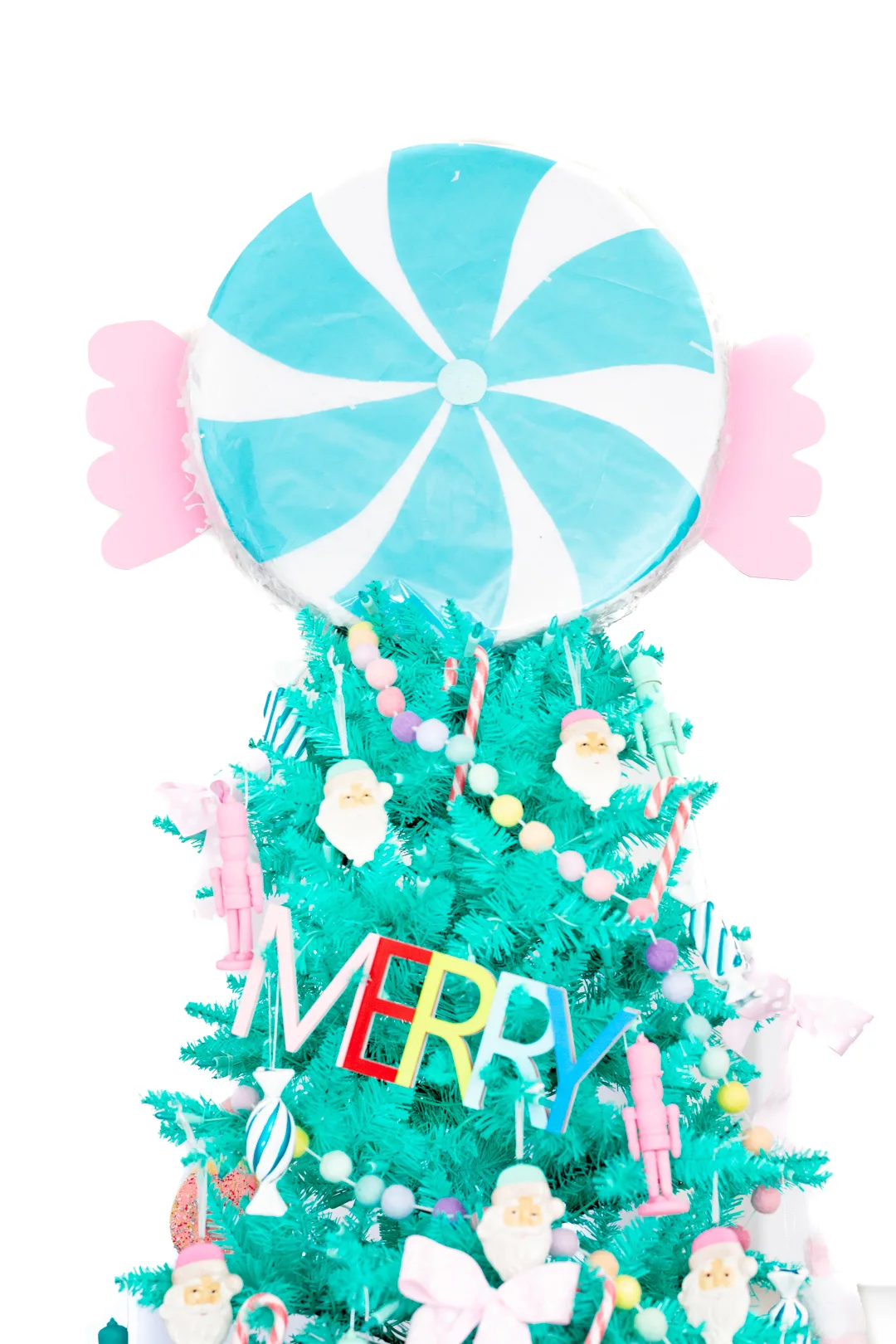 pretty teal christmas tree with peppermint pinata topper