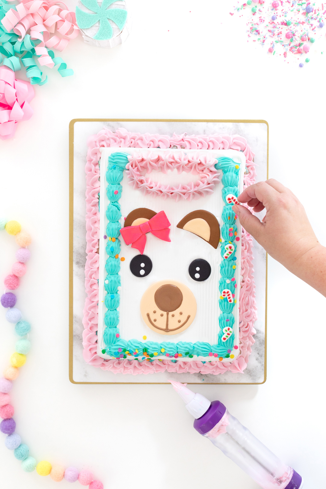 adding sprinkles to an ice cream cake