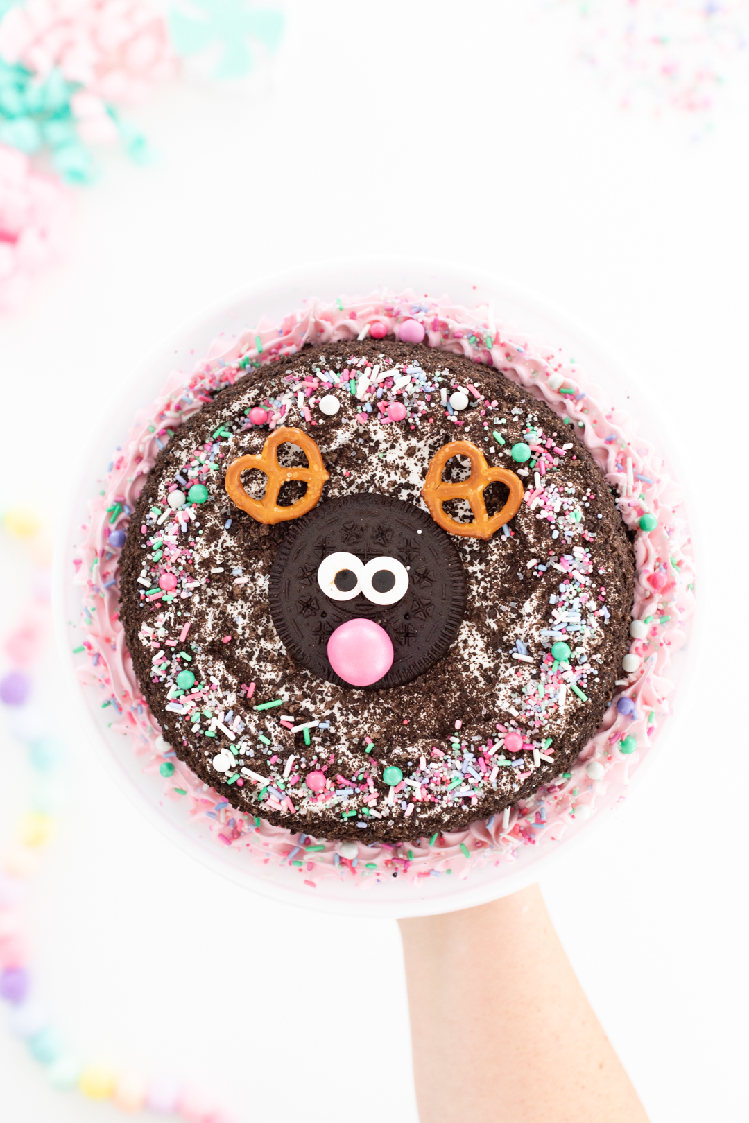 adorable ice cream cake with a reindeer in the center. pink gum ball nose