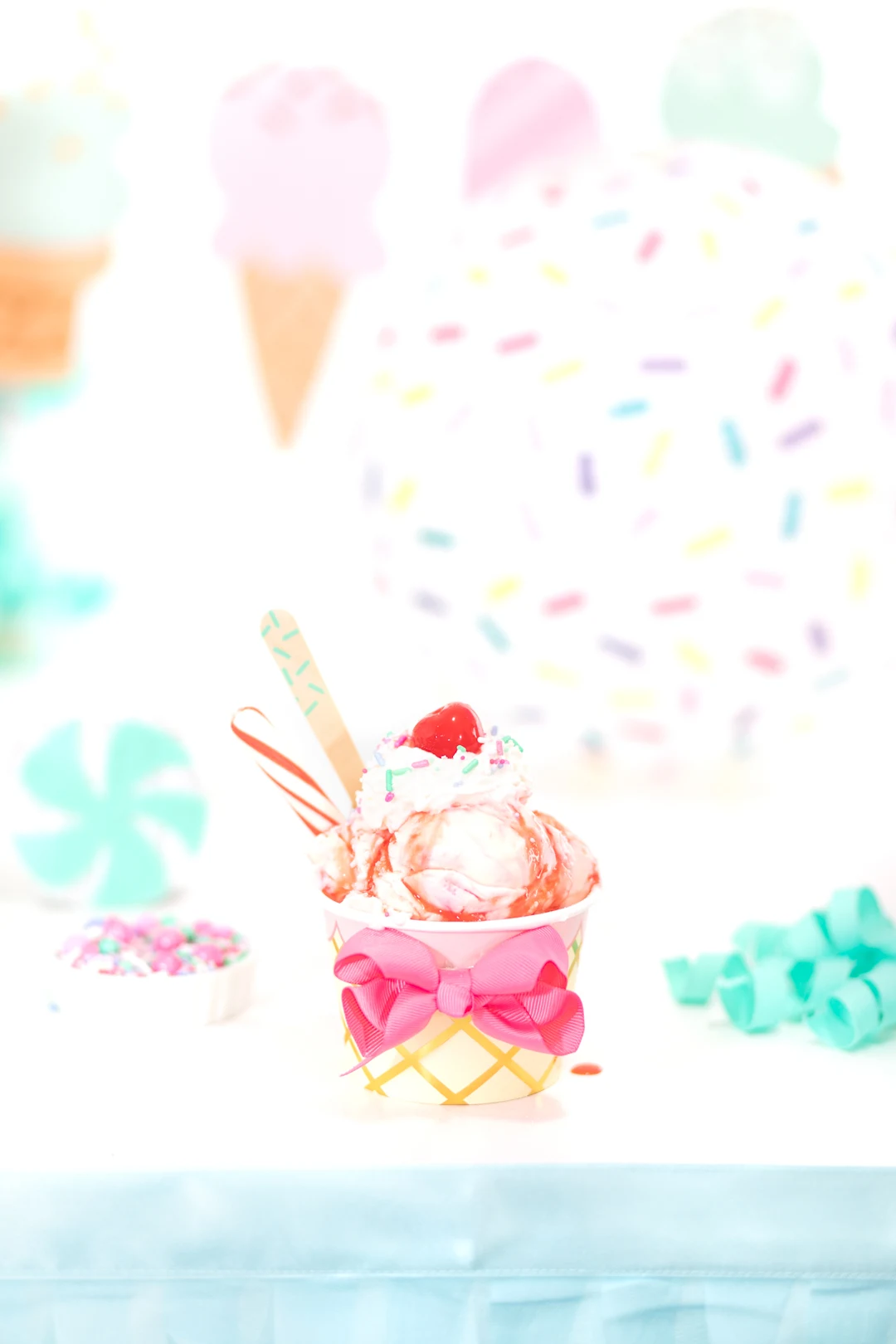 pretty ice cream sundae with candy cane and pink strawberry syrup