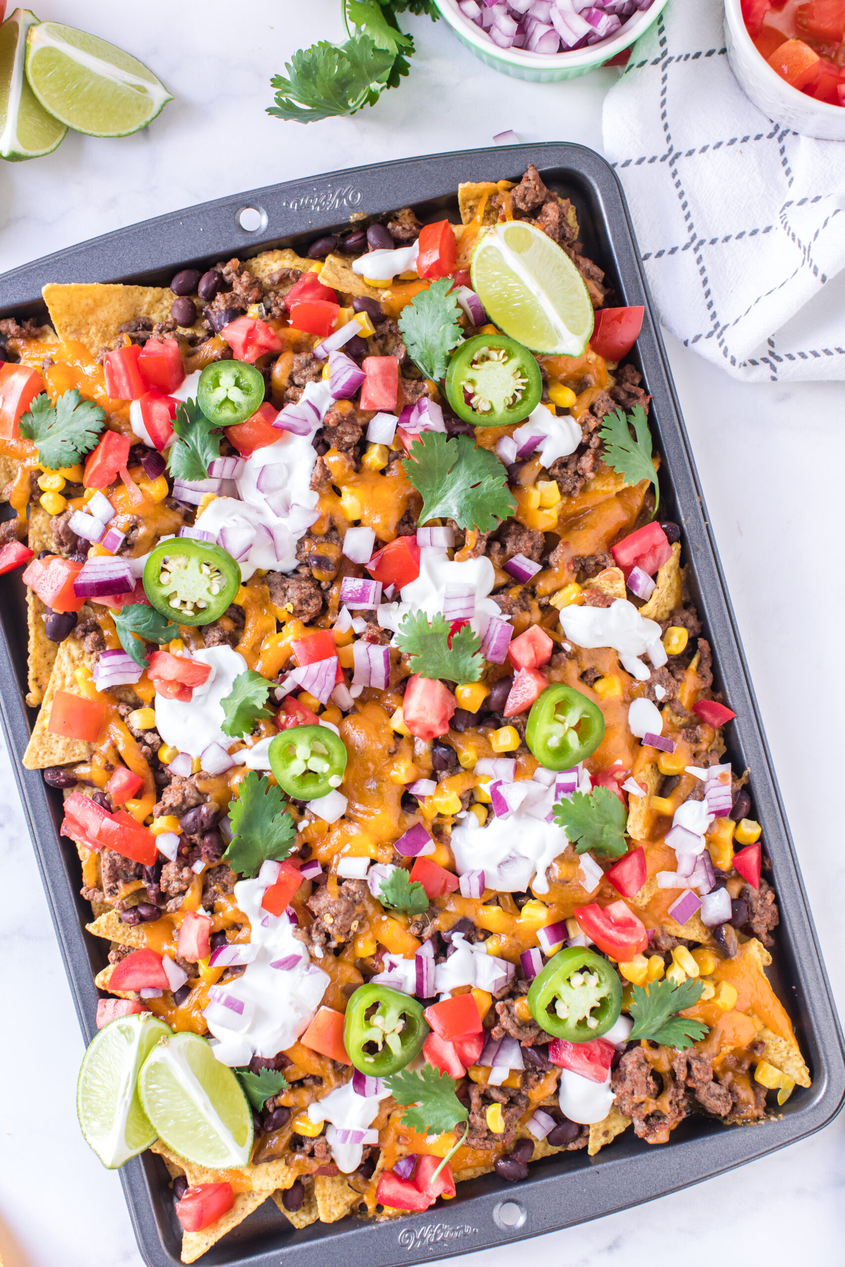 restaurant style nachos made on a sheet pan