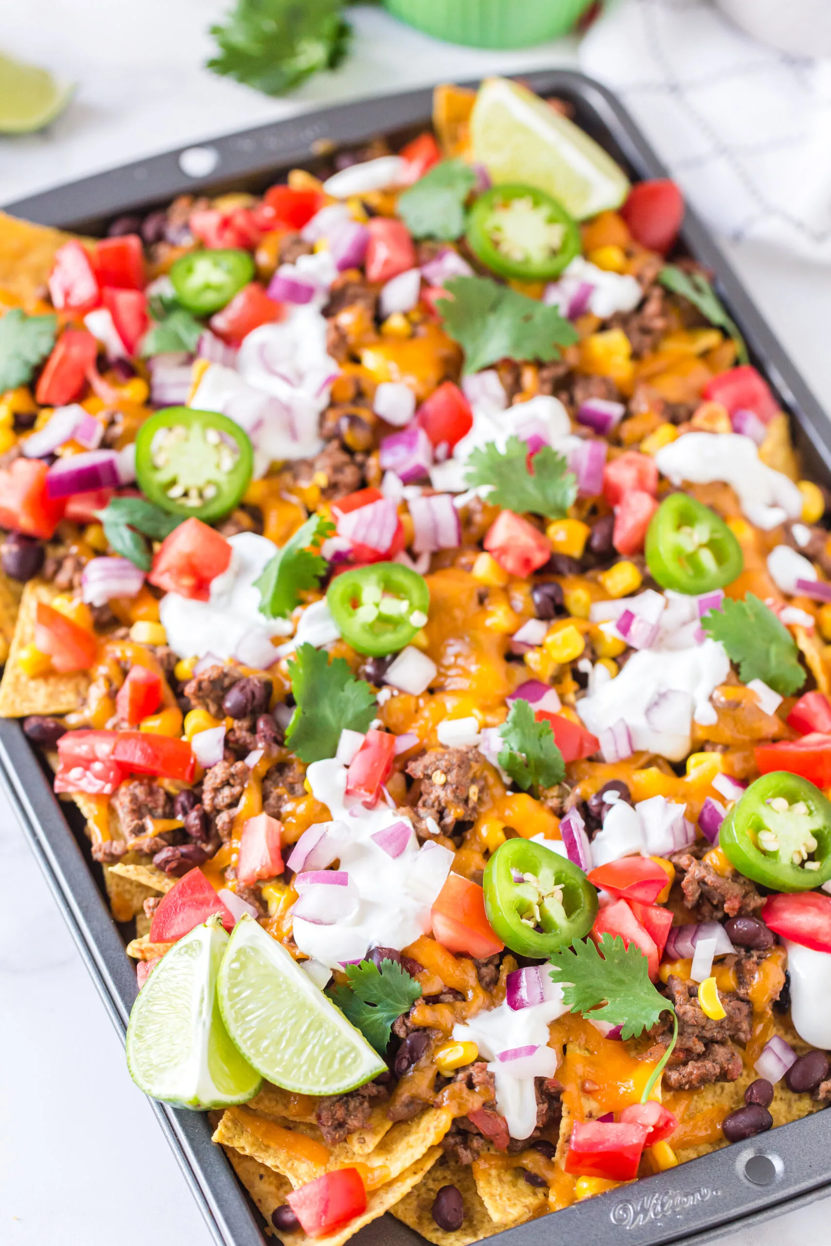 colorful nachos served on a baking sheet