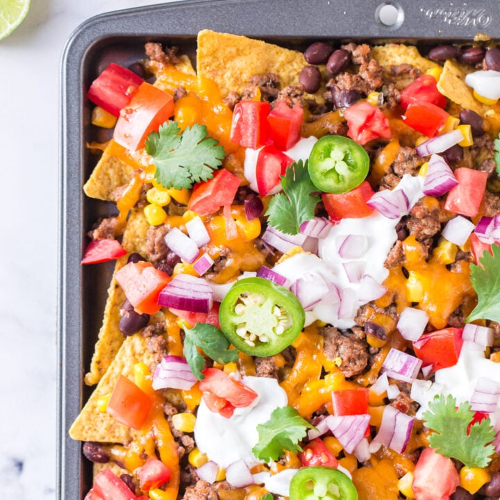 up close view of prepared nachos on a sheet pan