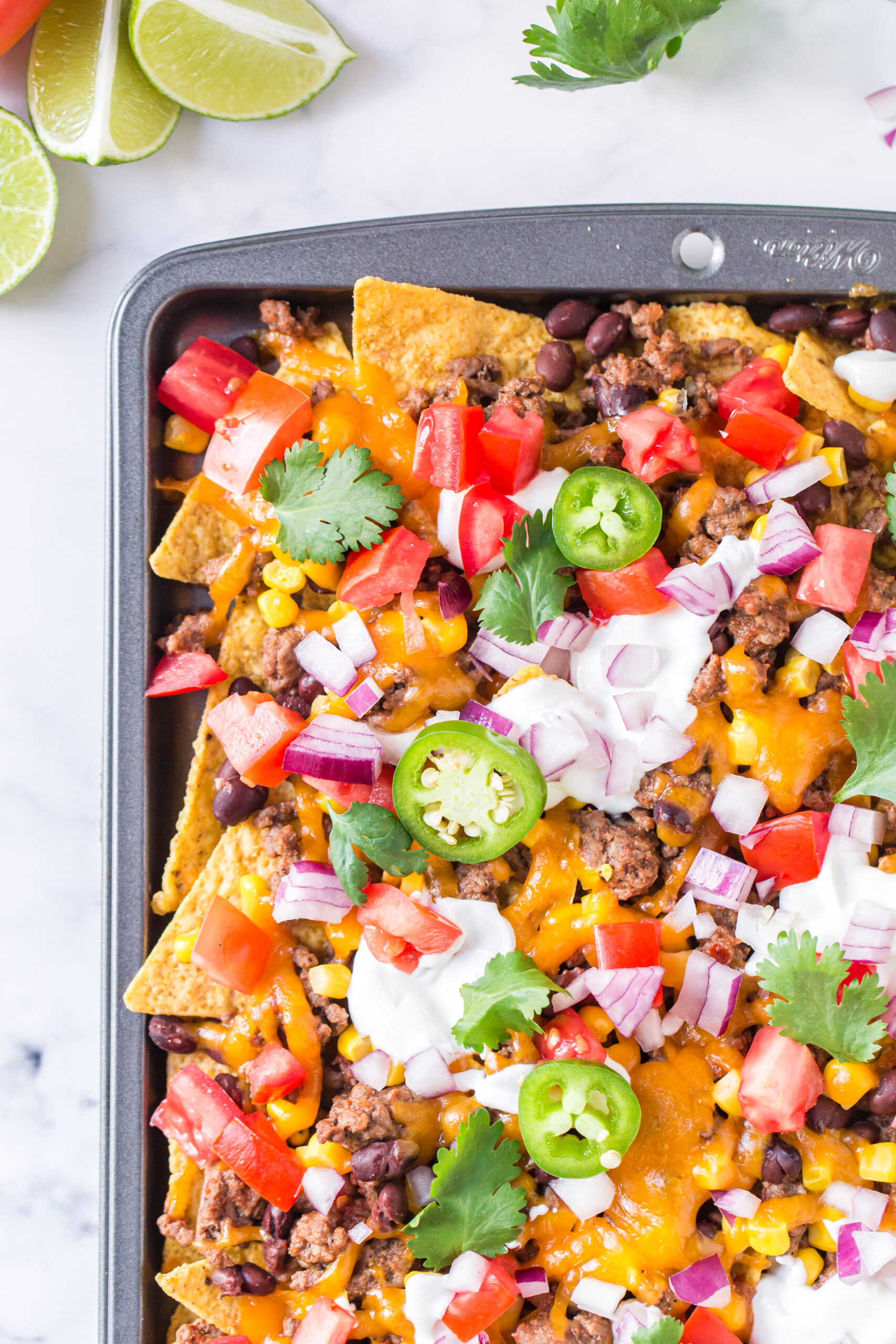 up close view of prepared nachos on a sheet pan