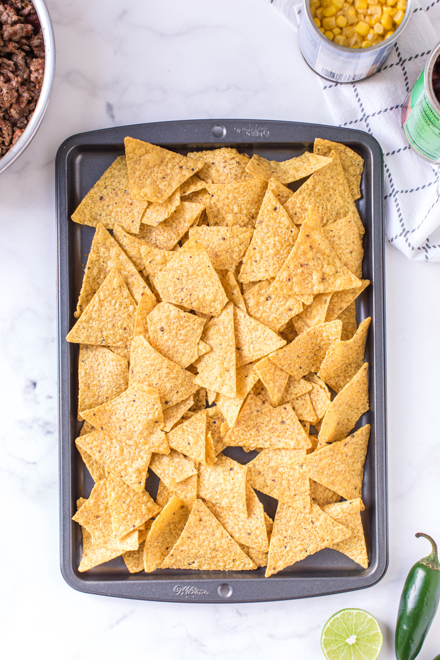 baking sheet with plain tortilla chips added