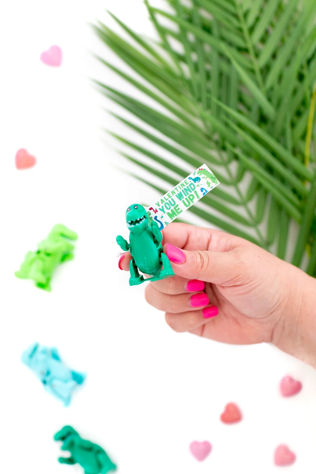 girl holding mini dino toy valentines day diy gift with printable gift tag