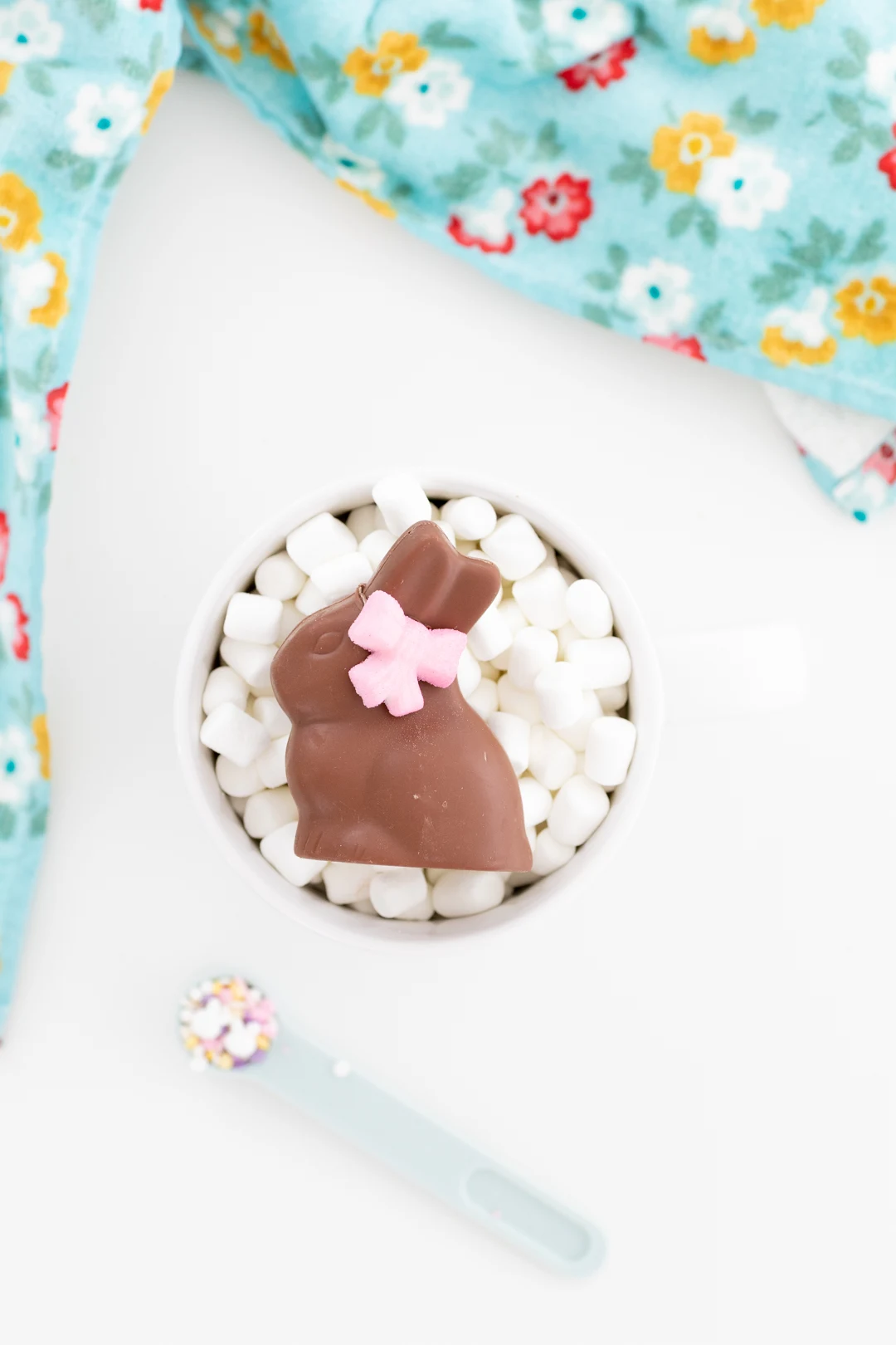 chocolate bunny inside a large mug loaded with mini marshmallows