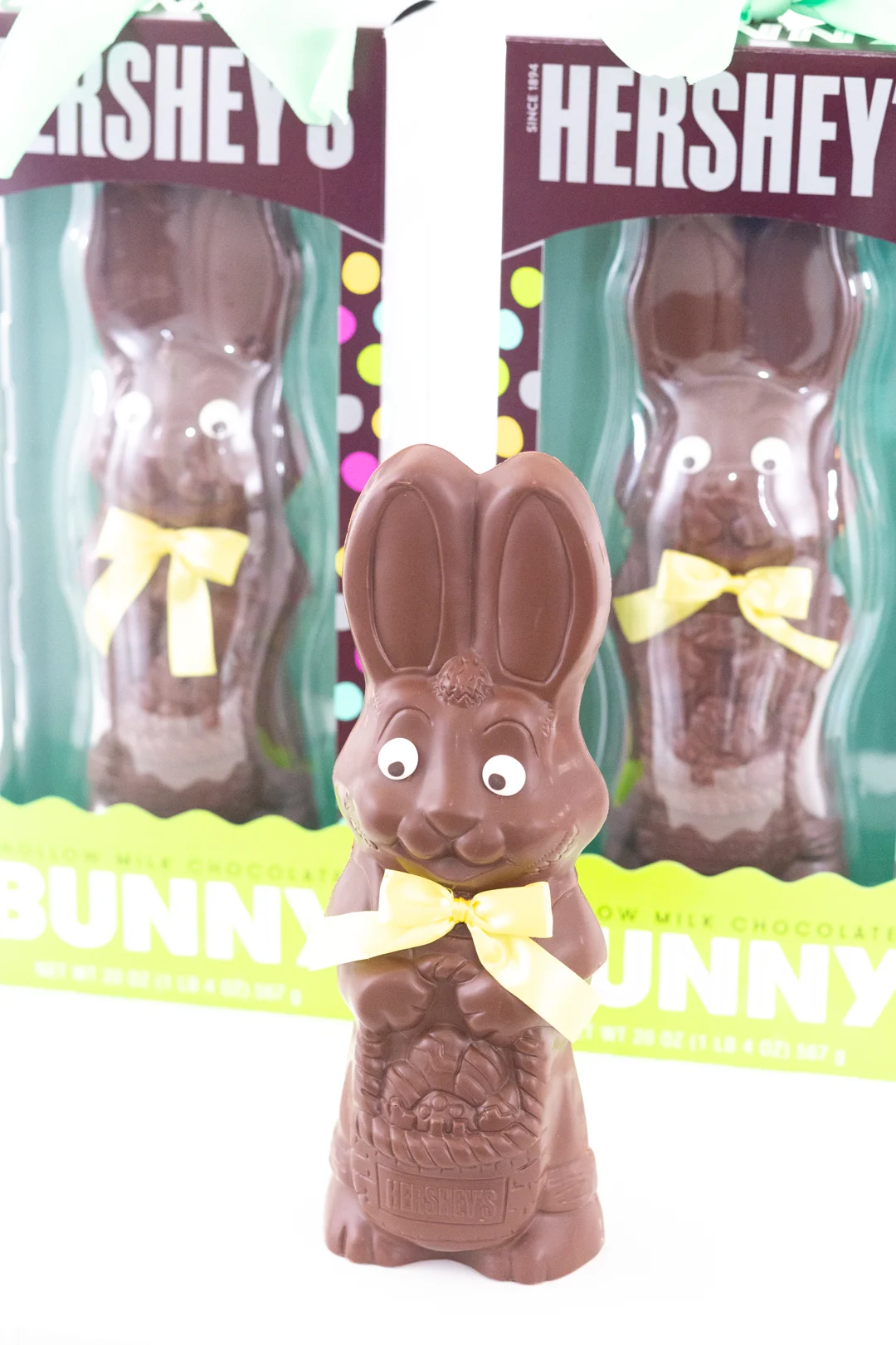 extra large chocolate easter bunny in front of the hersheys package