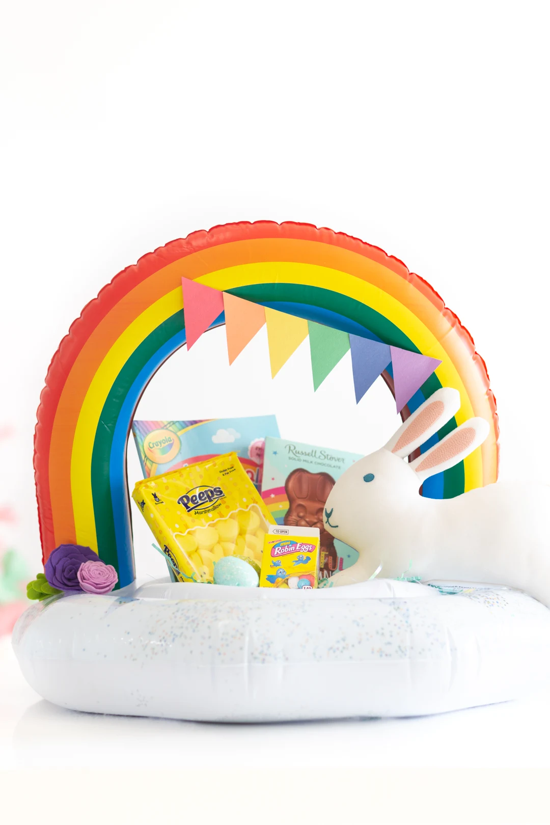 Alternate Easter Basket idea using a pool float. Cute construction paper rainbow to decorate.