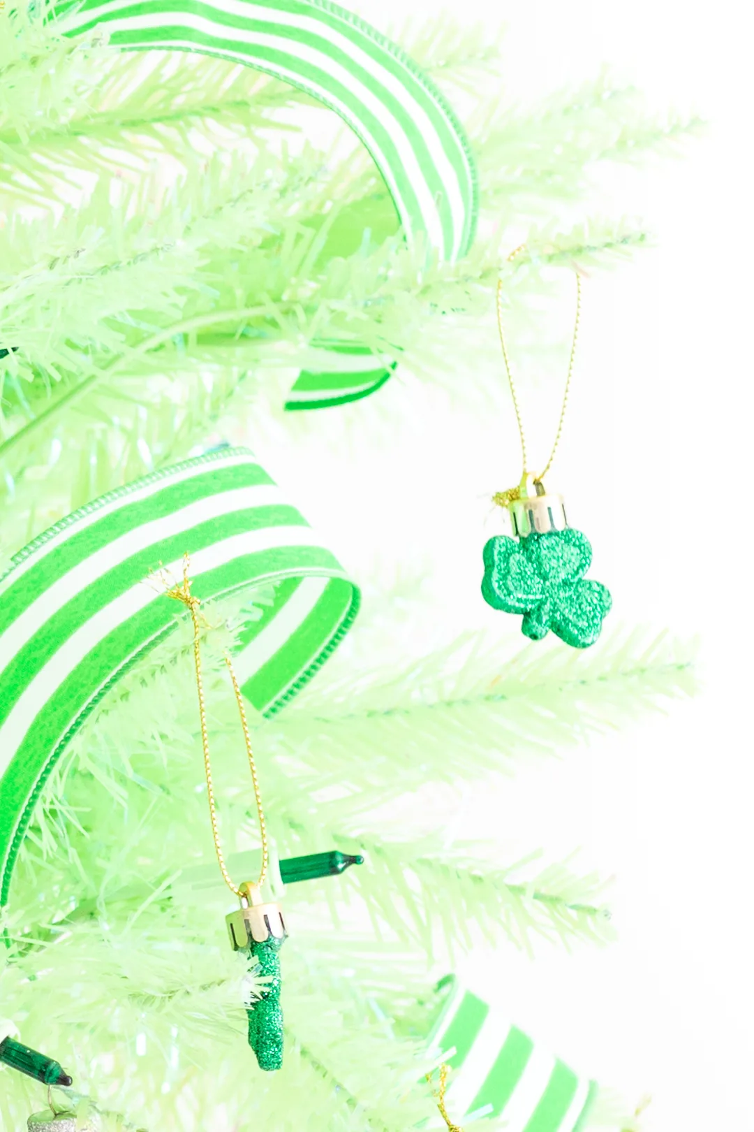 mini shamrock ornament on a light green christmas tree